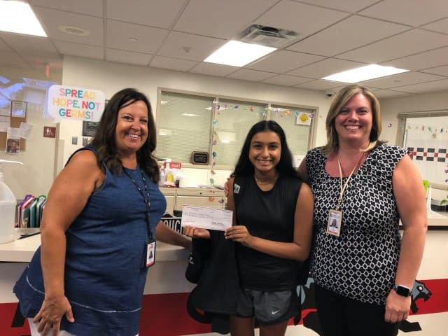 Kriti Gupta receiving a grant check for CCL-KIDS from school administrators